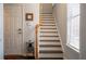 Inviting entryway with stairs, hardwood floors, and a white front door at 401 Iona Abbey Se Ct # 6, Smyrna, GA 30082