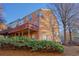 Brick townhouse back exterior with a wood deck and lush green landscaping at 401 Iona Abbey Se Ct # 6, Smyrna, GA 30082