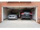 Two-car garage featuring two automobiles with additional storage space at 401 Iona Abbey Se Ct # 6, Smyrna, GA 30082