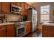 Gourmet kitchen features stainless steel appliances, tiled backsplash, and light countertops at 401 Iona Abbey Se Ct # 6, Smyrna, GA 30082