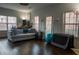 Spacious living room with hardwood floors, large windows, and a comfortable gray sofa at 401 Iona Abbey Se Ct # 6, Smyrna, GA 30082