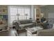 Bright living room showcasing a tufted couch, bookshelves, and modern decor at 401 Iona Abbey Se Ct # 6, Smyrna, GA 30082