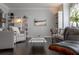 Living room featuring dark hardwood floors, grey walls, stylish furniture and built-in bookshelves at 401 Iona Abbey Se Ct # 6, Smyrna, GA 30082