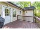 Back deck features a grill and provides an outdoor area overlooking mature trees at 2208 Clarendon Ne Ct, Conyers, GA 30012