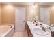 Bright bathroom features double sink vanity and a large soaking tub at 2208 Clarendon Ne Ct, Conyers, GA 30012