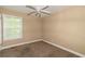 Bedroom features neutral walls, carpet, and a window providing natural light at 2208 Clarendon Ne Ct, Conyers, GA 30012