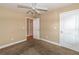 Bedroom with neutral walls, carpet flooring, and a door leading to another room at 2208 Clarendon Ne Ct, Conyers, GA 30012