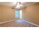 Neutral bedroom with a window providing natural light and a ceiling fan at 2208 Clarendon Ne Ct, Conyers, GA 30012