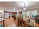 Well-lit dining area featuring wood floors, rustic table and chairs, and open access to the kitchen and deck at 2208 Clarendon Ne Ct, Conyers, GA 30012