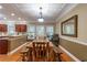 Cozy dining area with wood floors, rustic furniture, and convenient access to both the kitchen and backyard at 2208 Clarendon Ne Ct, Conyers, GA 30012