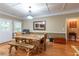 Inviting dining area featuring a rustic table, wood floors, and natural light, perfect for Gathering gatherings at 2208 Clarendon Ne Ct, Conyers, GA 30012