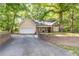 Inviting home exterior featuring a two-car garage, classic curb appeal and lush natural surroundings at 2208 Clarendon Ne Ct, Conyers, GA 30012