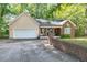 Traditional home featuring a two-car garage, front porch, brick accent, and a well-maintained driveway at 2208 Clarendon Ne Ct, Conyers, GA 30012