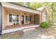 Charming front porch with wood flooring, chair and brick accent on the side of the house at 2208 Clarendon Ne Ct, Conyers, GA 30012