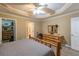 Serene primary bedroom with wood accents, neutral tones, and access to walk-in closet and bathroom at 2208 Clarendon Ne Ct, Conyers, GA 30012