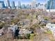 Located at 289 9th Street, this aerial view shows the house in a neighborhood setting with the skyline in the background at 289 9Th Ne St, Atlanta, GA 30309