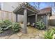 Charming backyard featuring a pergola, seating area, stone pathway, and mature landscaping at 289 9Th Ne St, Atlanta, GA 30309