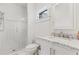 Clean bathroom featuring a glass enclosed shower, white tile, and a vanity with marble countertop at 289 9Th Ne St, Atlanta, GA 30309