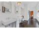 Bright bathroom featuring double sinks, white subway tile, glass shower, and hardwood flooring at 289 9Th Ne St, Atlanta, GA 30309