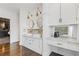 Stylish bathroom featuring dual sinks with marble countertops, white cabinets, and unique lighting fixtures at 289 9Th Ne St, Atlanta, GA 30309