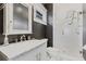 Contemporary bathroom featuring dark gray walls, a glass enclosed shower, and a marble countertop at 289 9Th Ne St, Atlanta, GA 30309