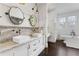 Bright bathroom features a dual sink vanity with granite countertop and stylish bronze hardware at 289 9Th Ne St, Atlanta, GA 30309