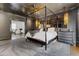 Modern bedroom with a four-poster bed, gray walls, gray carpet, and modern decor at 289 9Th Ne St, Atlanta, GA 30309