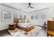 Sunlit bedroom features a large bed, modern ceiling fan, and multiple windows with neighborhood views at 289 9Th Ne St, Atlanta, GA 30309