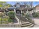 Beautiful home with a stone wall, manicured lawn, and decorative wrought iron fence at 289 9Th Ne St, Atlanta, GA 30309