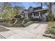 Lovely home with mature trees, a brick driveway, and a wrought iron fence at 289 9Th Ne St, Atlanta, GA 30309