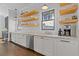 Bright kitchen area with white cabinets, marble countertops, and floating shelves creates a clean and modern look at 289 9Th Ne St, Atlanta, GA 30309