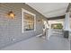 Charming covered porch featuring gray floors, a white railing, and detailed trim at 289 9Th Ne St, Atlanta, GA 30309