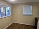 Bright kitchen area with wood flooring, a double window, and white cabinets at 2976 Nelson Dr, Duluth, GA 30096