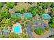 Aerial view showcasing tennis courts, basketball court, swimming pool, and paved parking area at 4260 River Club Dr, Cumming, GA 30041