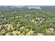 Aerial view of the home surrounded by lush trees near Lake Lanier at 4260 River Club Dr, Cumming, GA 30041