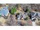 Stunning aerial view of a beautiful house with mature trees on a landscaped lot at 4260 River Club Dr, Cumming, GA 30041