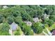 An aerial view of upscale homes nestled among mature trees in a residential community at 4260 River Club Dr, Cumming, GA 30041