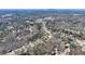 Wide aerial shot exhibiting neighborhood's layout, showcasing the numerous homes surrounded by trees, and convenient location at 4260 River Club Dr, Cumming, GA 30041