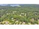 Aerial view of the home surrounded by lush trees near Lake Lanier at 4260 River Club Dr, Cumming, GA 30041