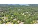 Aerial view of the home surrounded by lush trees near Lake Lanier at 4260 River Club Dr, Cumming, GA 30041
