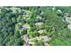 Aerial view of the home surrounded by lush trees in a well-established neighborhood at 4260 River Club Dr, Cumming, GA 30041