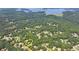 Beautiful aerial view of a home in a wooded community with lake views, encircled in yellow at 4260 River Club Dr, Cumming, GA 30041