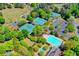 A complete view of all the tennis courts and a swimming pool, surrounded by lush trees at 4260 River Club Dr, Cumming, GA 30041
