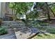 Landscaped backyard featuring a wood path, stone steps, and tiered planting beds enhancing its natural appeal at 4260 River Club Dr, Cumming, GA 30041