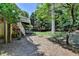 Multi-level backyard with steps to the deck, mature trees, and a stepping stone path at 4260 River Club Dr, Cumming, GA 30041