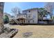 Expansive backyard features a spacious lawn, a multi-level deck, and mature trees at 4260 River Club Dr, Cumming, GA 30041