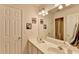 Bathroom with a double vanity, large mirror, decorative art, and a doorway to a shower at 4260 River Club Dr, Cumming, GA 30041