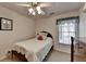 Inviting bedroom featuring a bed, dresser, a window with curtains, and a ceiling fan at 4260 River Club Dr, Cumming, GA 30041