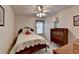 A cozy bedroom featuring a bed, dresser, window with curtains, and a ceiling fan at 4260 River Club Dr, Cumming, GA 30041