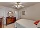 Bedroom with a bed, wood dresser, ceiling fan, and a view into another room at 4260 River Club Dr, Cumming, GA 30041